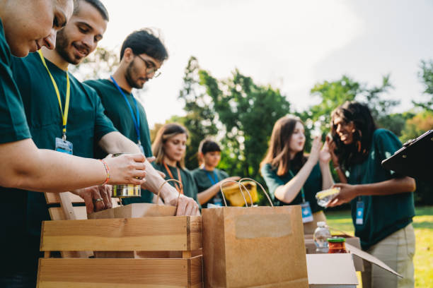 Volunteers are preparing donation boxes at the food and clothes bank. Humanitarian aid project concept.
